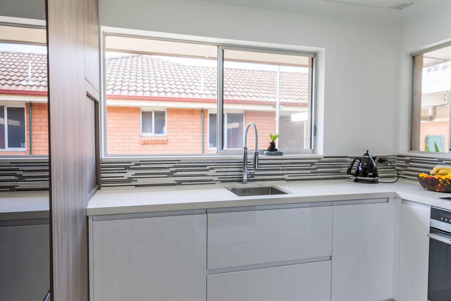 Modern Kitchen With White Cabinets — PKJ Design in Unanderra, NSW