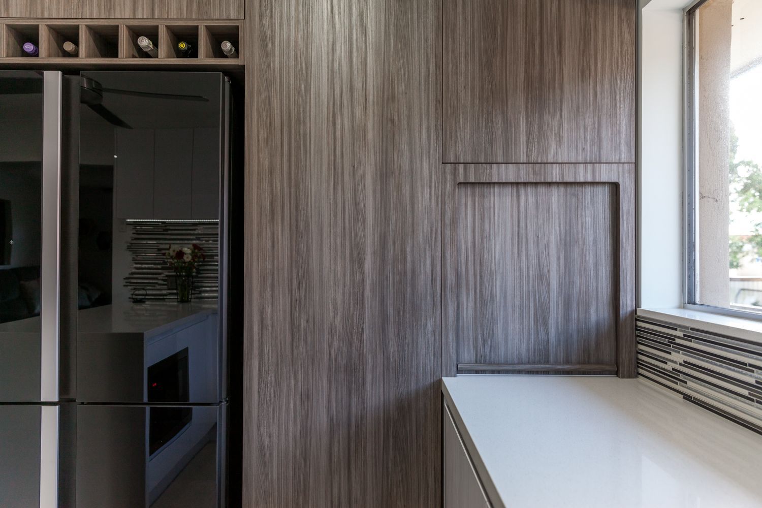 Modern Kitchen With Dark Wood Cabinets — PKJ Design in Unanderra, NSW