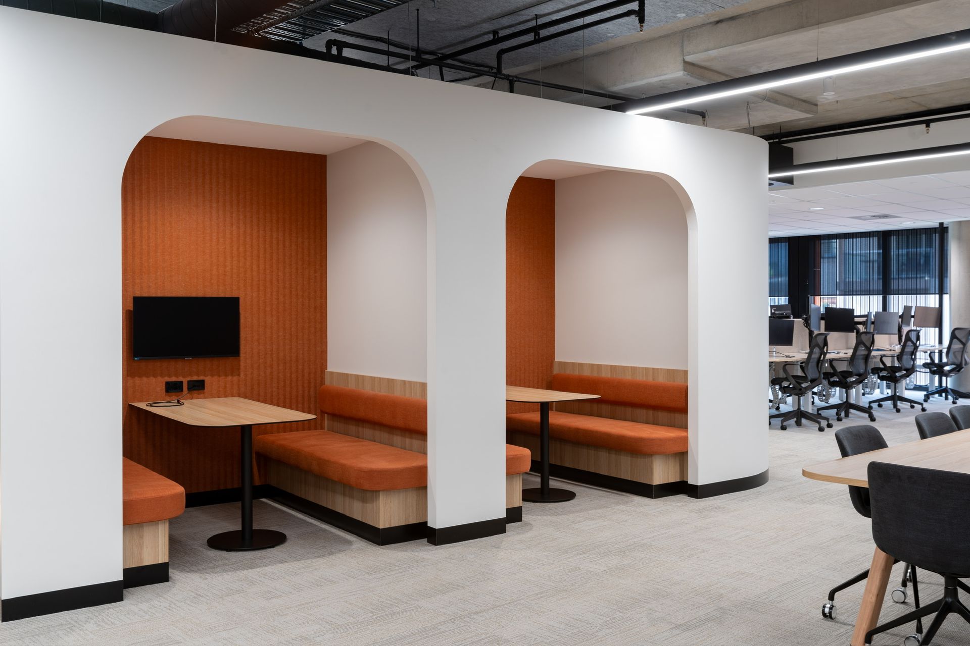 Modern Office Lounge With Orange Booth Seating — PKJ Design in Unanderra, NSW