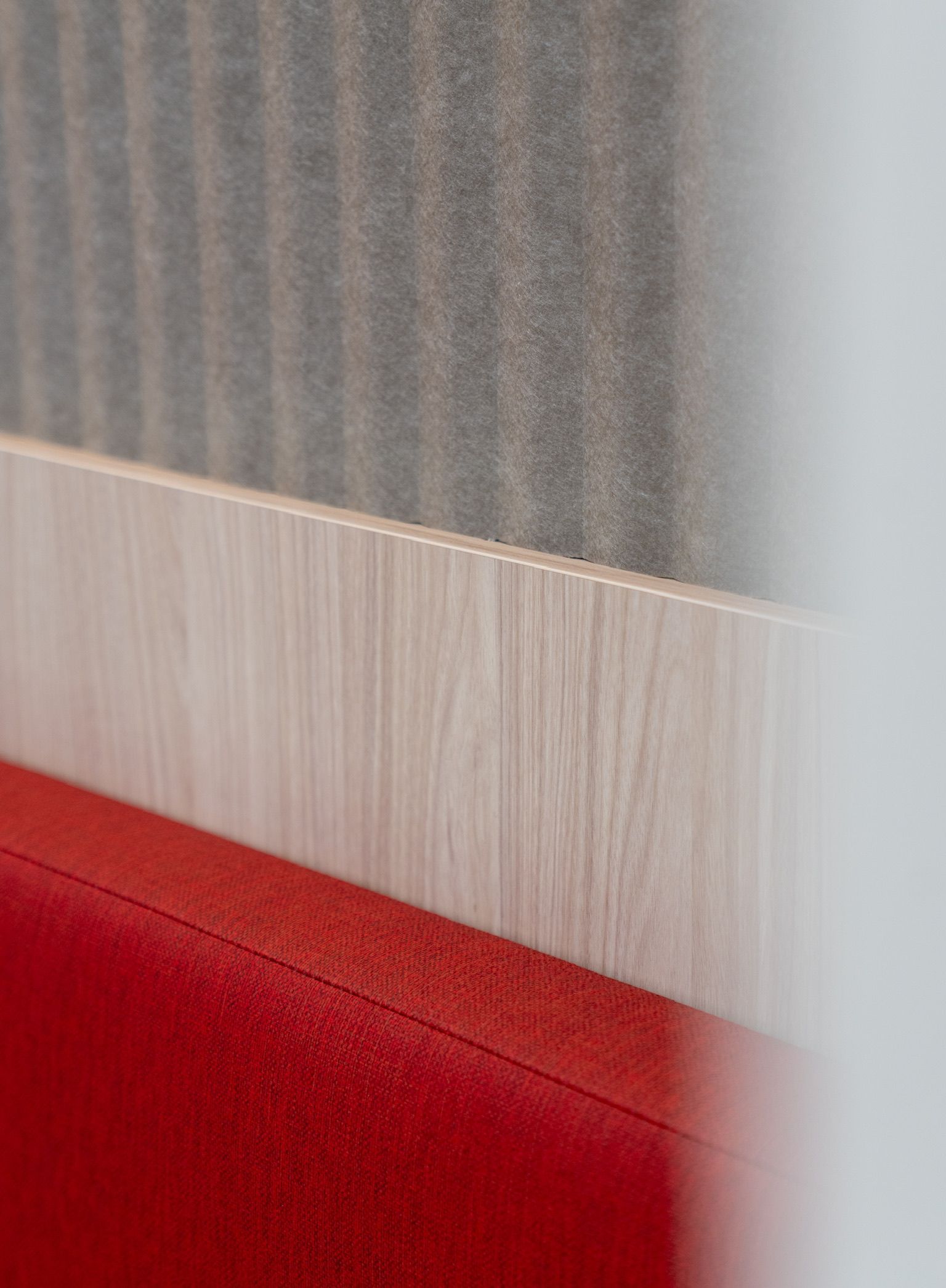 Red Bench Backrest Against Light Wood and Gray Textured Wall — PKJ Design in Unanderra, NSW