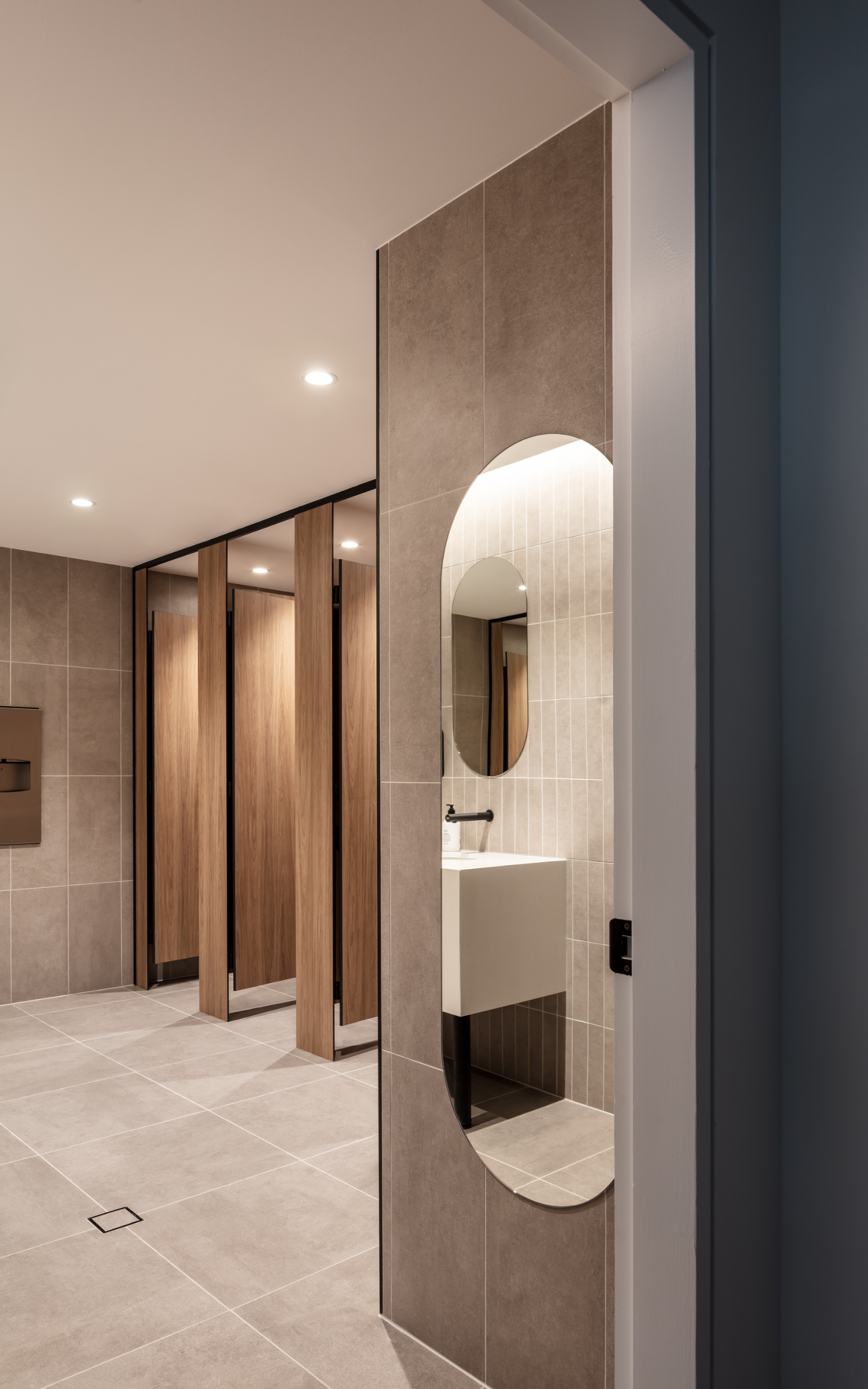 Modern Restroom Hallway With Wooden Stalls — PKJ Design in Unanderra, NSW
