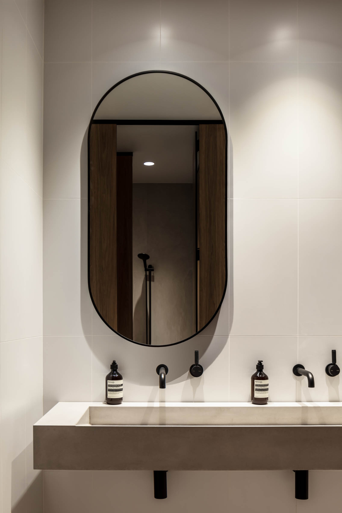 Minimalist Bathroom Vanity With Oval Mirror — PKJ Design in Unanderra, NSW
