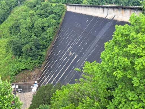 An aerial view of Lake Fontana Dam surrounded by trees.