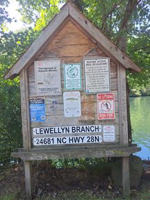 A wooden bulletin board with a sign that says Lewellyn Branch