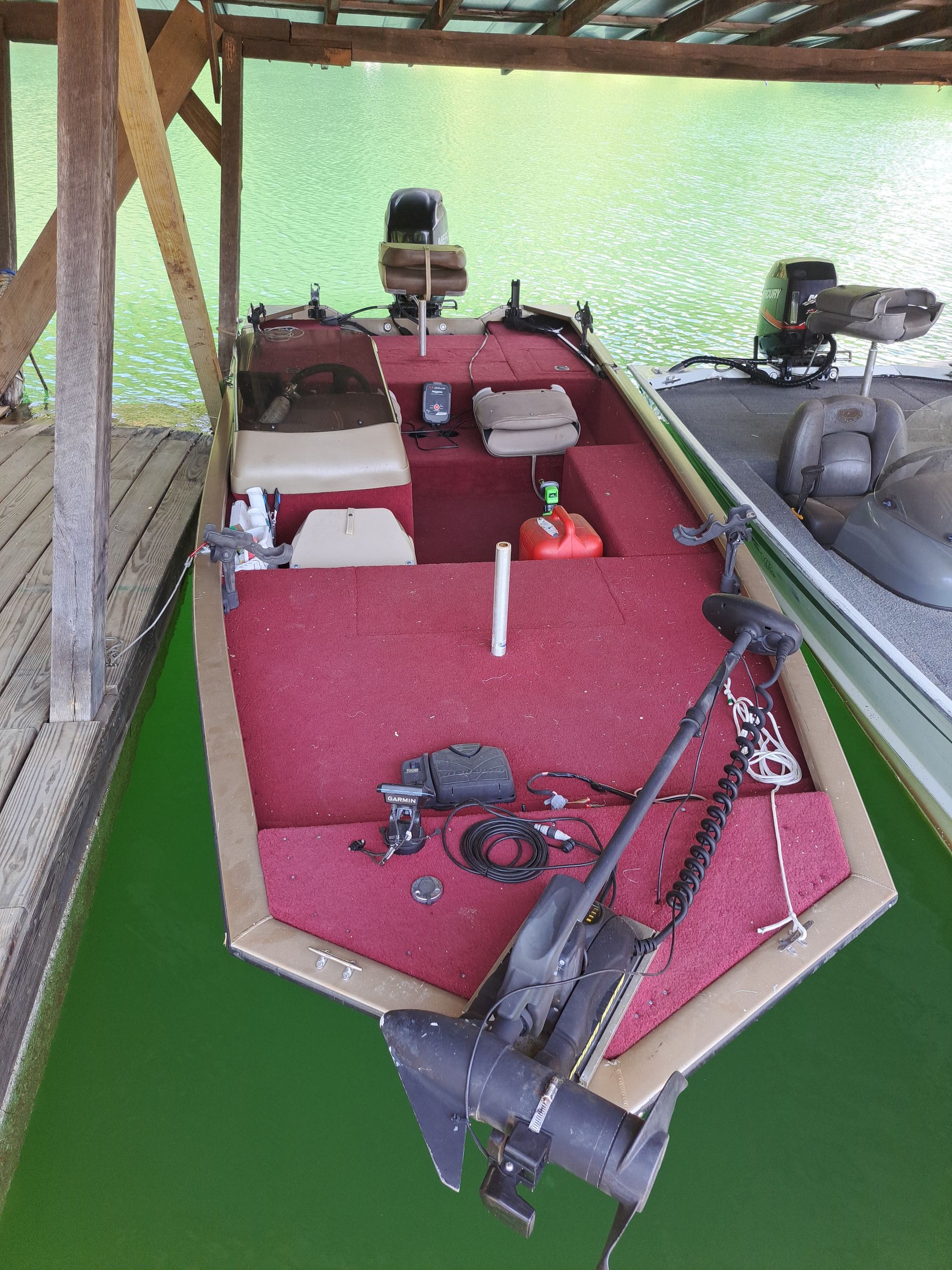 A boat with a motor is sitting in a dock.