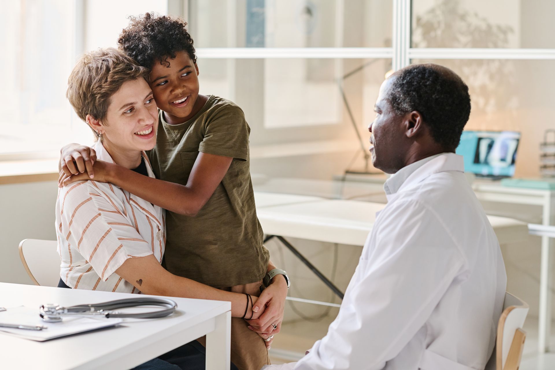 Person hugging a doctor during a consultation in a bright clinic office