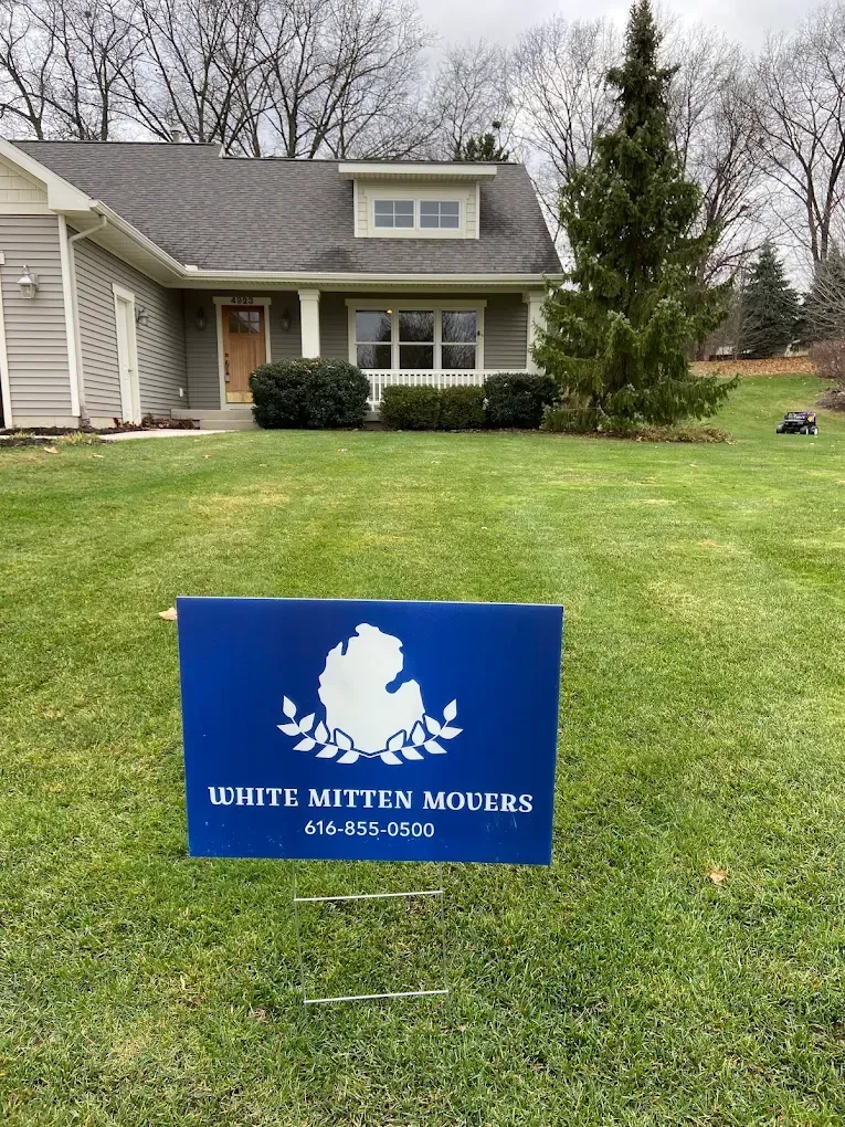 Blue yard sign reading “White Matter Matters” in front of a house on a lawn