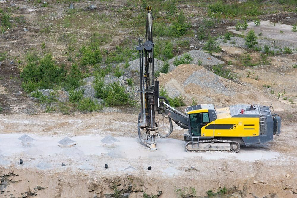 A Yellow and Black Machine Is Drilling a Hole in The Ground  — Hillery Group in Bowen, QLD
