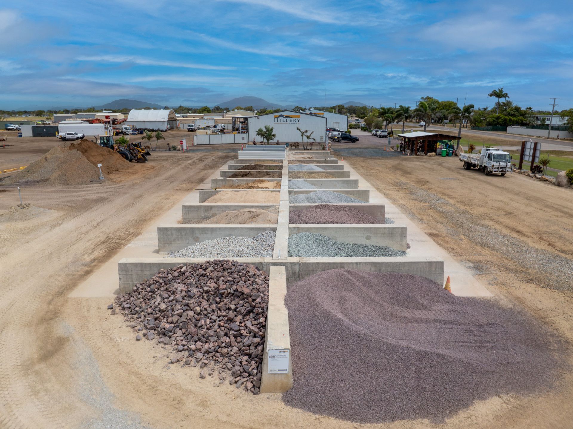 Gravel And Stone Piles Arranged in Rows at a Construction Site Under a Cloudy Sky — Hillery Group in Bowen, QLD