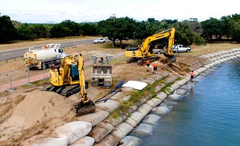 A Group of Construction Workers Are Working on A Project Next to A Body of Water — Hillery Group in Belmore, NSW