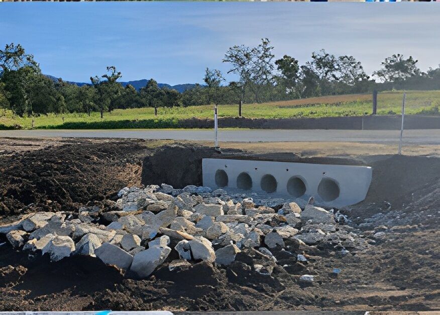 A Pile of Rocks Sits in The Dirt Near a Road — Hillery Group in Bowen, QLD