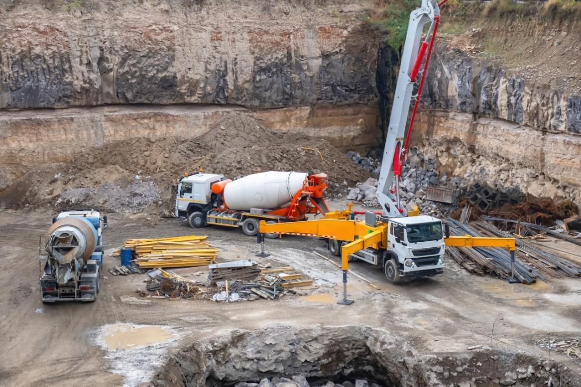 A Concrete Pump is Being Used to Pump Concrete Into a Hole — Hillery Group in Bowen, QLD
