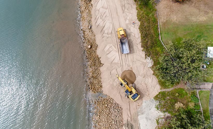 An Aerial View of A Construction Site Next to A Body of Water — Hillery Group in Belmore, NSW