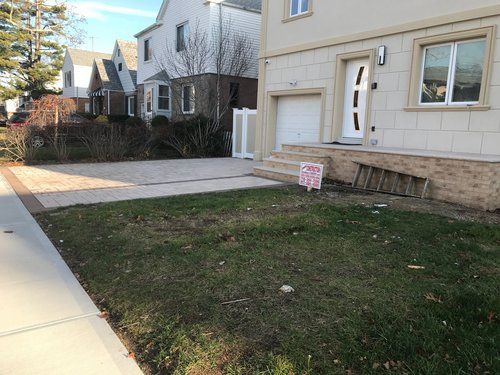 A house with a for sale sign in front of it.
