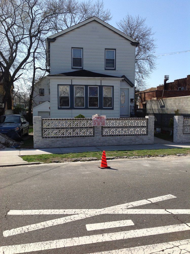 A white house with a red cone in front of it