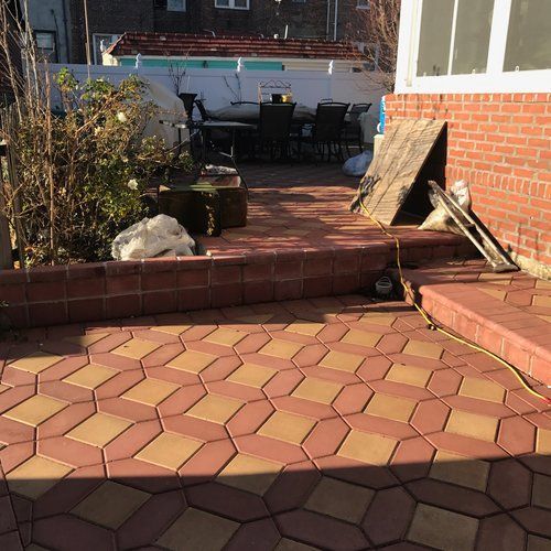 A brick patio in front of a brick building