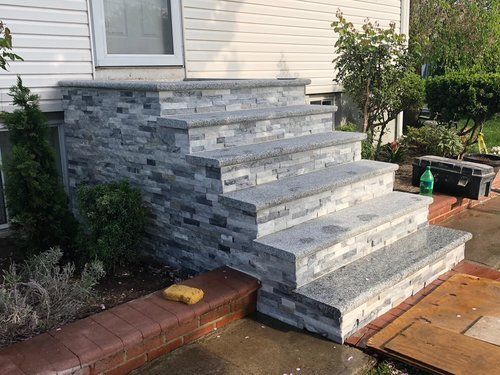 A set of stone stairs leading up to a house.