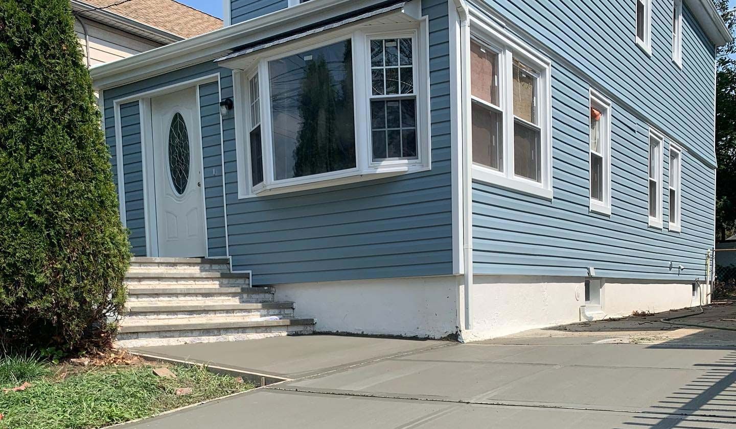 A blue house with stairs leading up to the front door