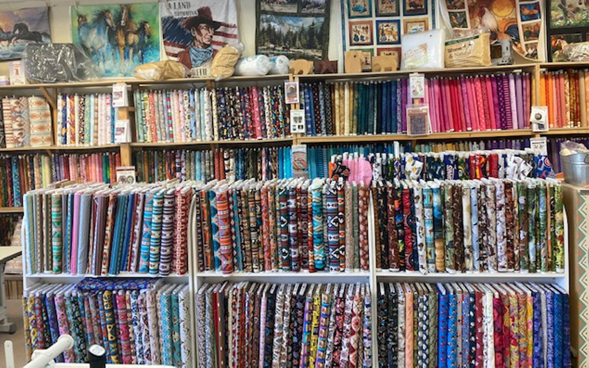 There are many different types of fabrics on the shelves in this store.