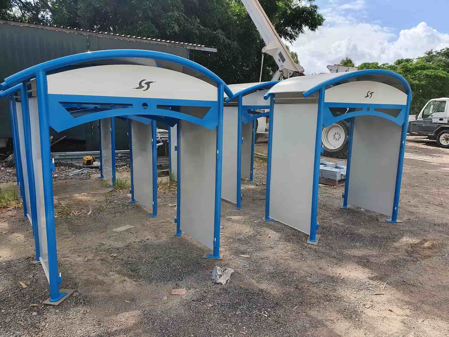 A Group of Blue and White Buildings Are Sitting on Top of a Dirt Field — Waters Abrasive Blasting Services In Innisfail, QLD