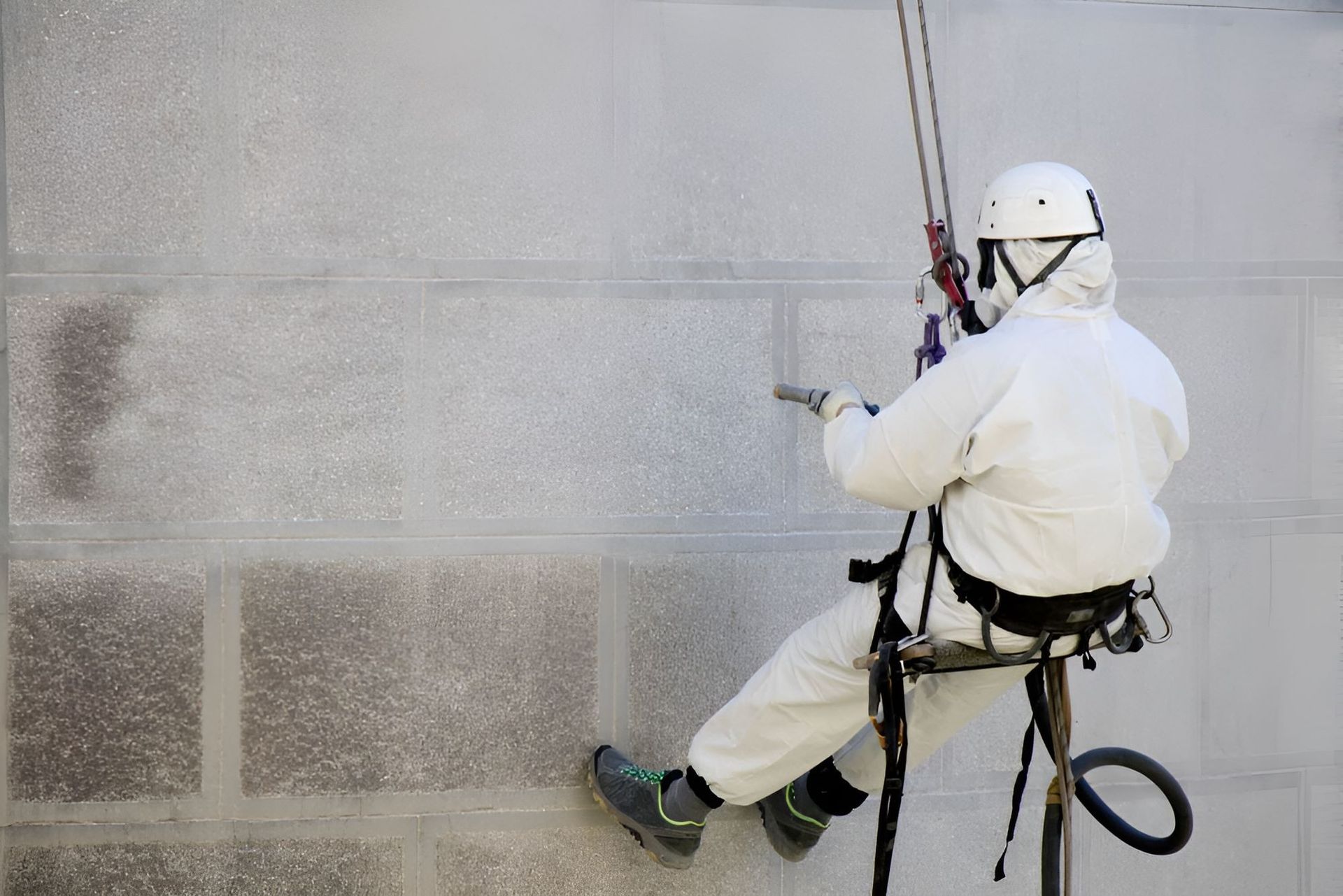 Black Waterproofing Applied to a Cinder Block Foundation Wall — Waters Abrasive Blasting Services In Gladstone, QLD