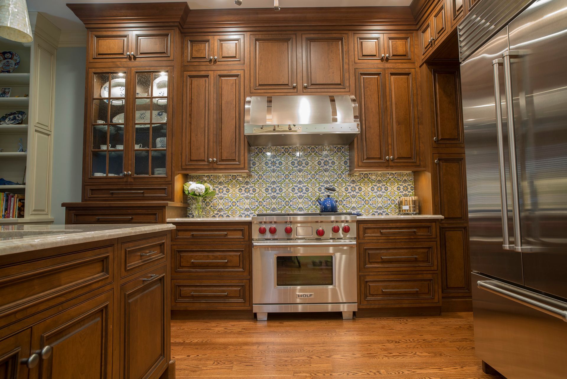 Traditional kitchen with wood cabinets, stainless steel range and refrigerator.