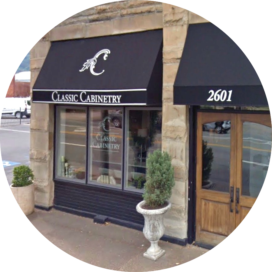 A store front with a black awning that says classic cabinetry