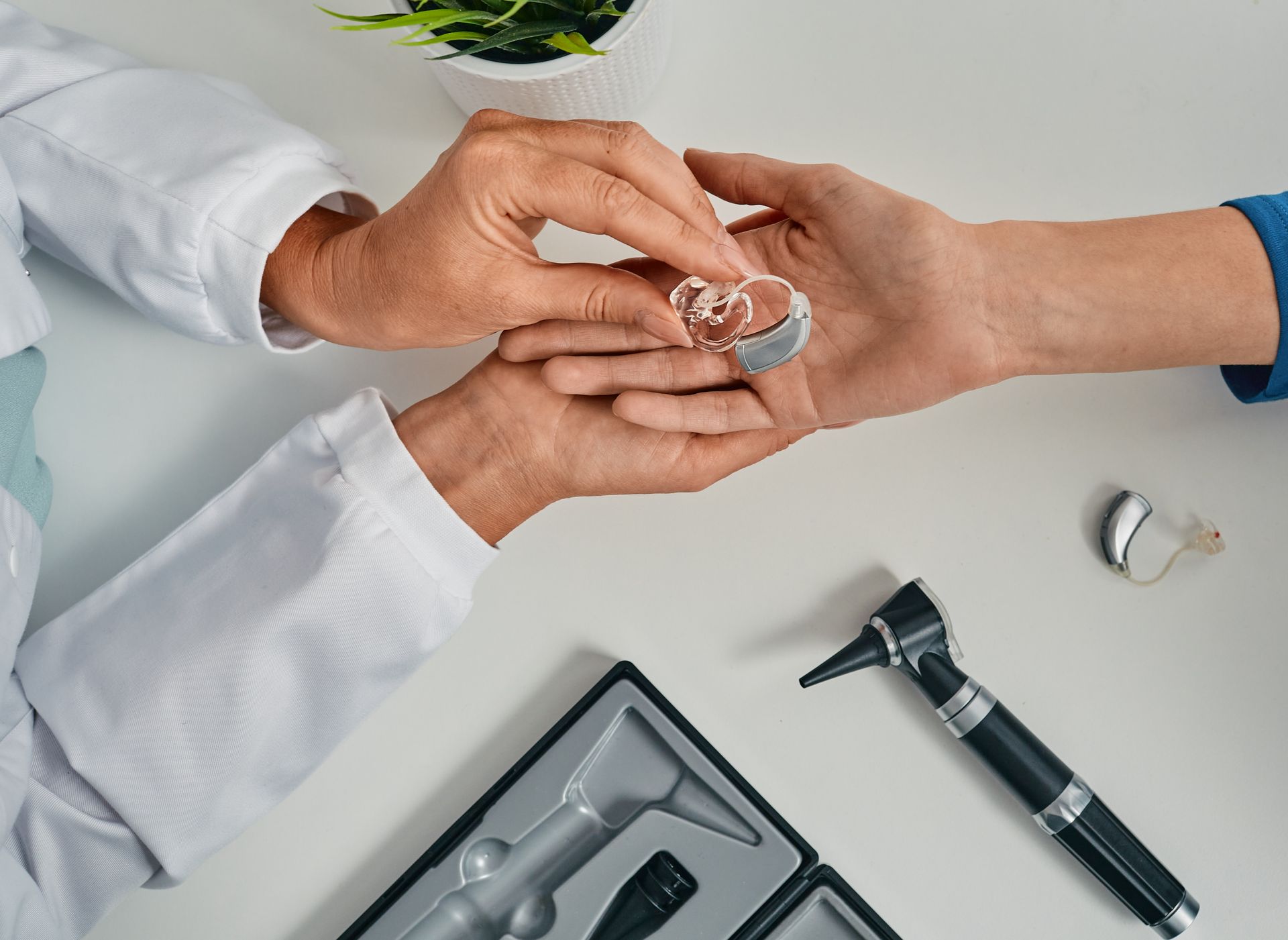 Giving Hearing Aid to Patient