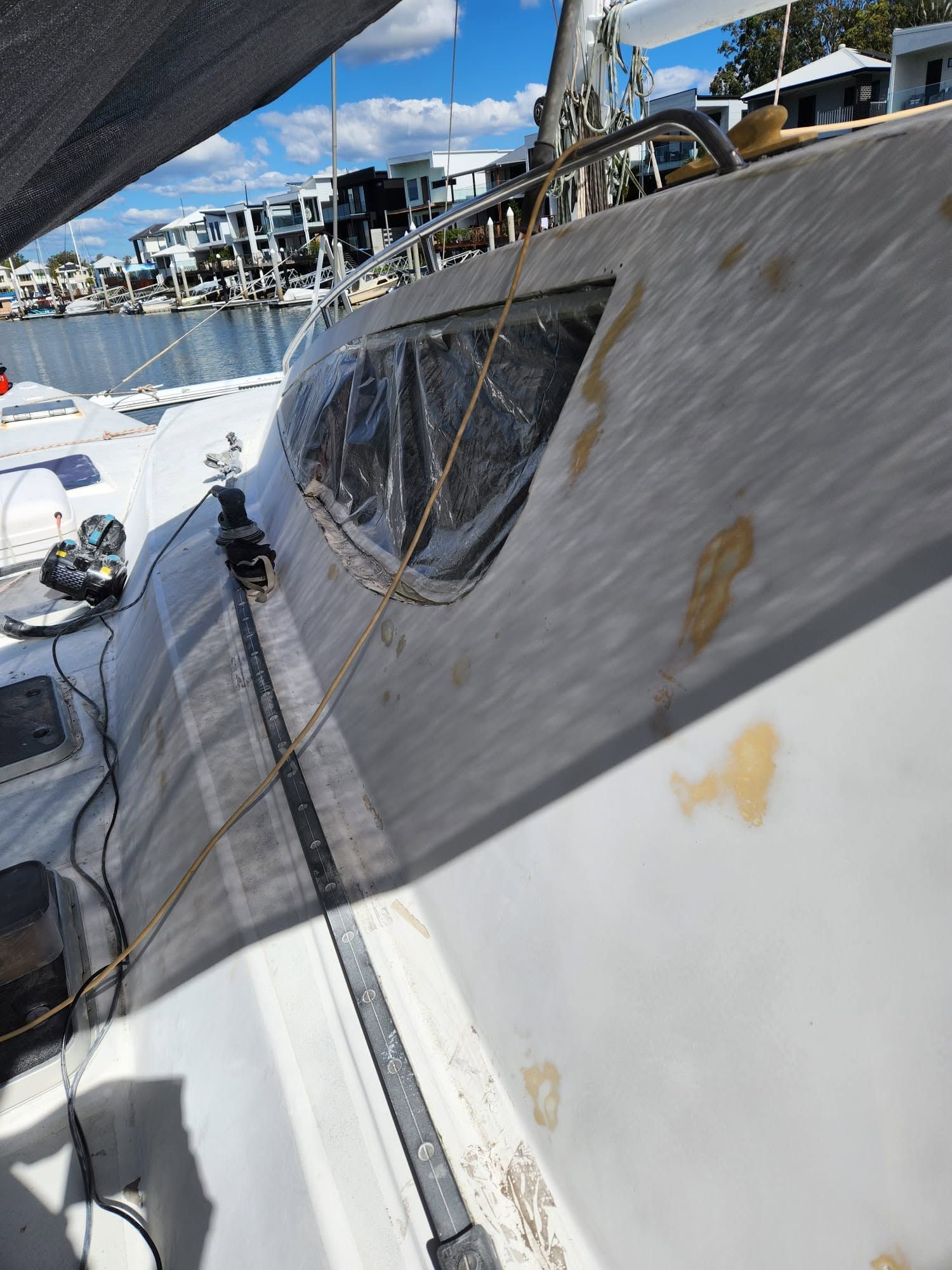 Sailboat Deck With a Netted Hatch and Yellow Stains — Baran Yachting in Sunshine Coast, QLD