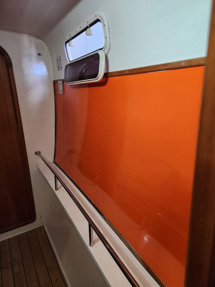 Narrow Boat Cabin With Orange Wall Panel — Baran Yachting in Maroochydore, QLD
