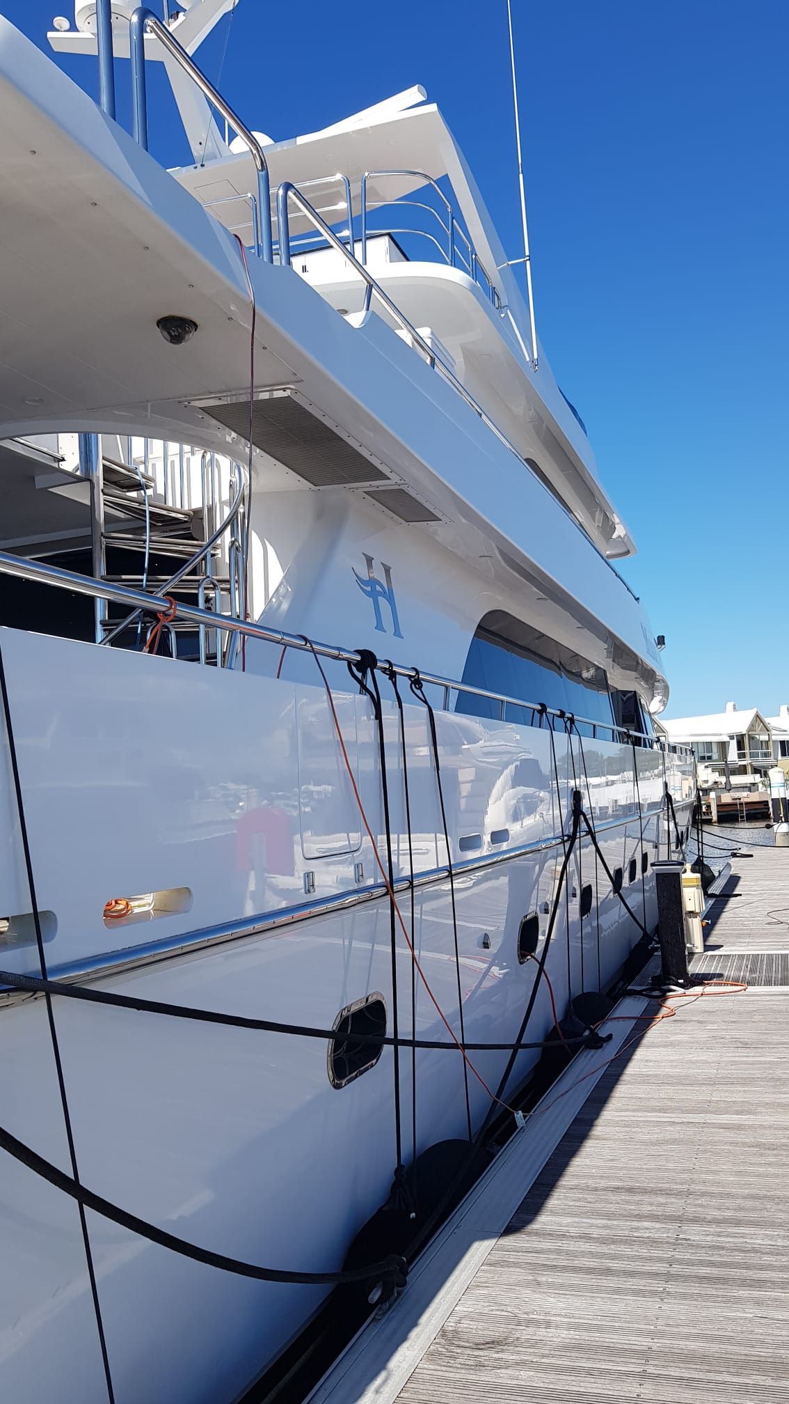 A Large White Yacht is Docked at a Marina on a Sunny Day — Baran Yachting in Tin Can Bay, QLD