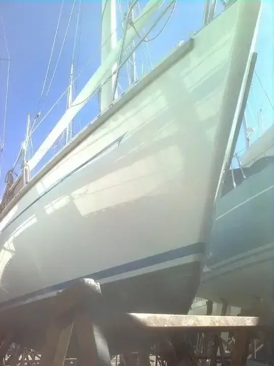 A White Sailboat is Sitting on a Dock — Baran Yachting in Sunshine Coast, QLD