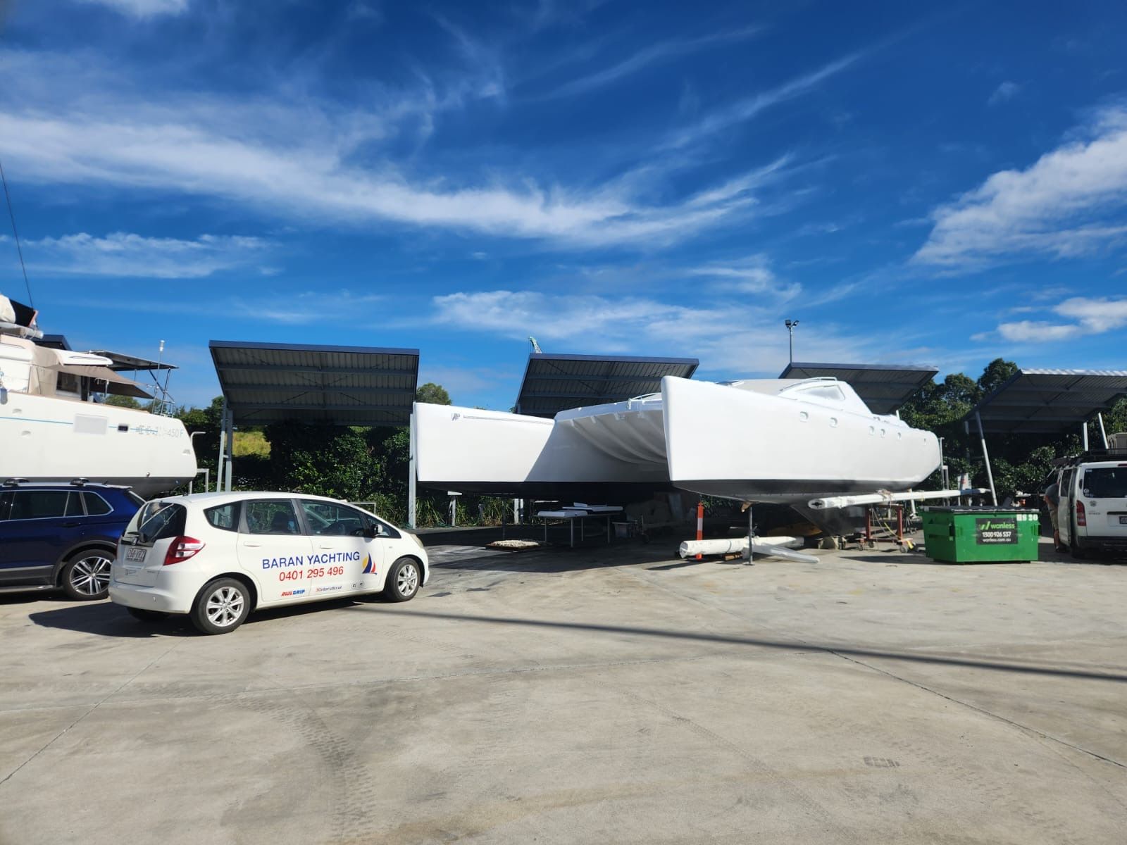 A White Car is Parked in a Parking Lot Next to a Boat — Baran Yachting in Sunshine Coast, QLD