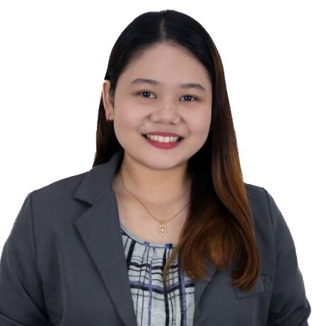Headshot of a smiling person in a gray blazer and patterned blouse on a white background