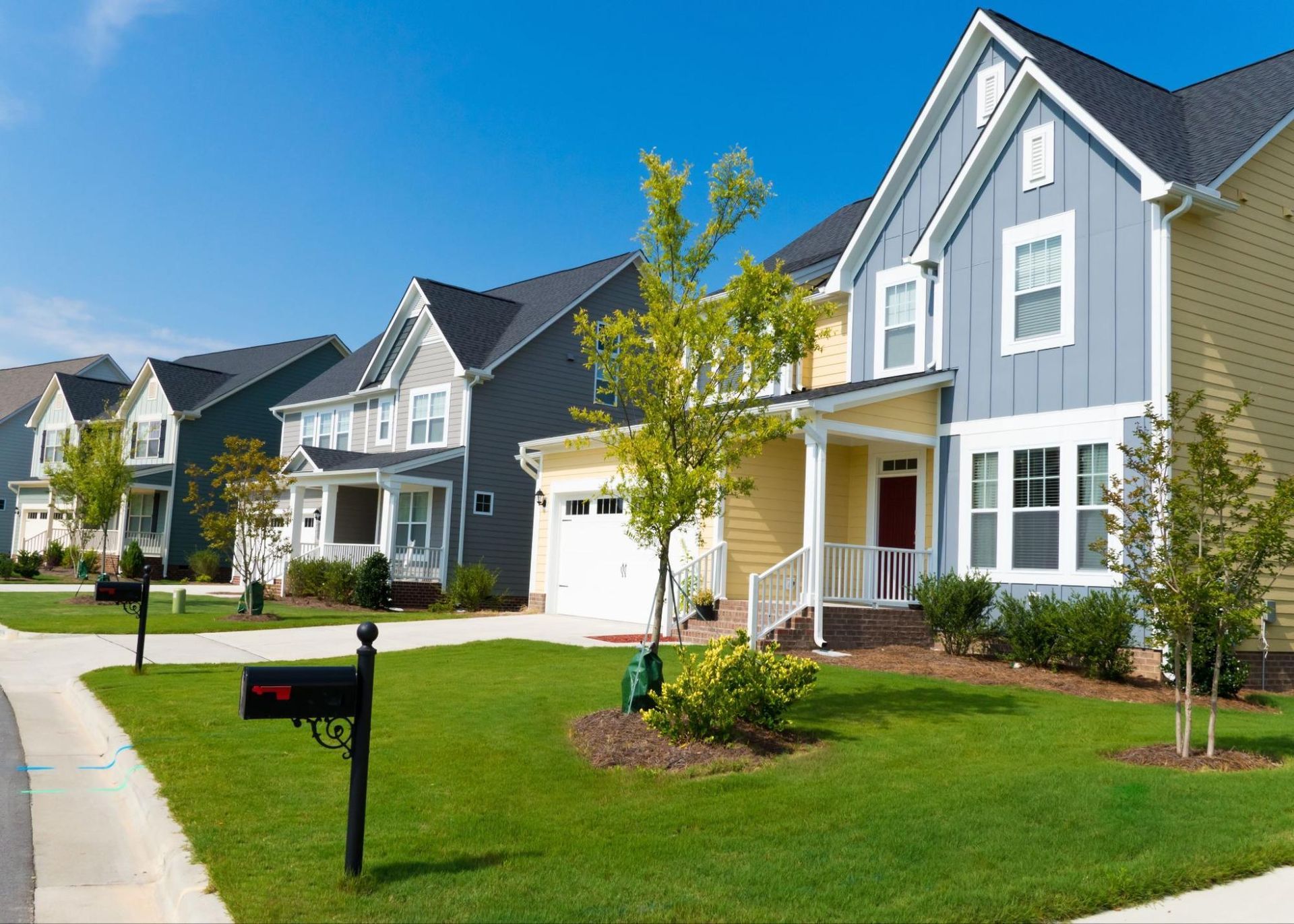 A row of houses in a residential neighborhood with a mailbox in front of them