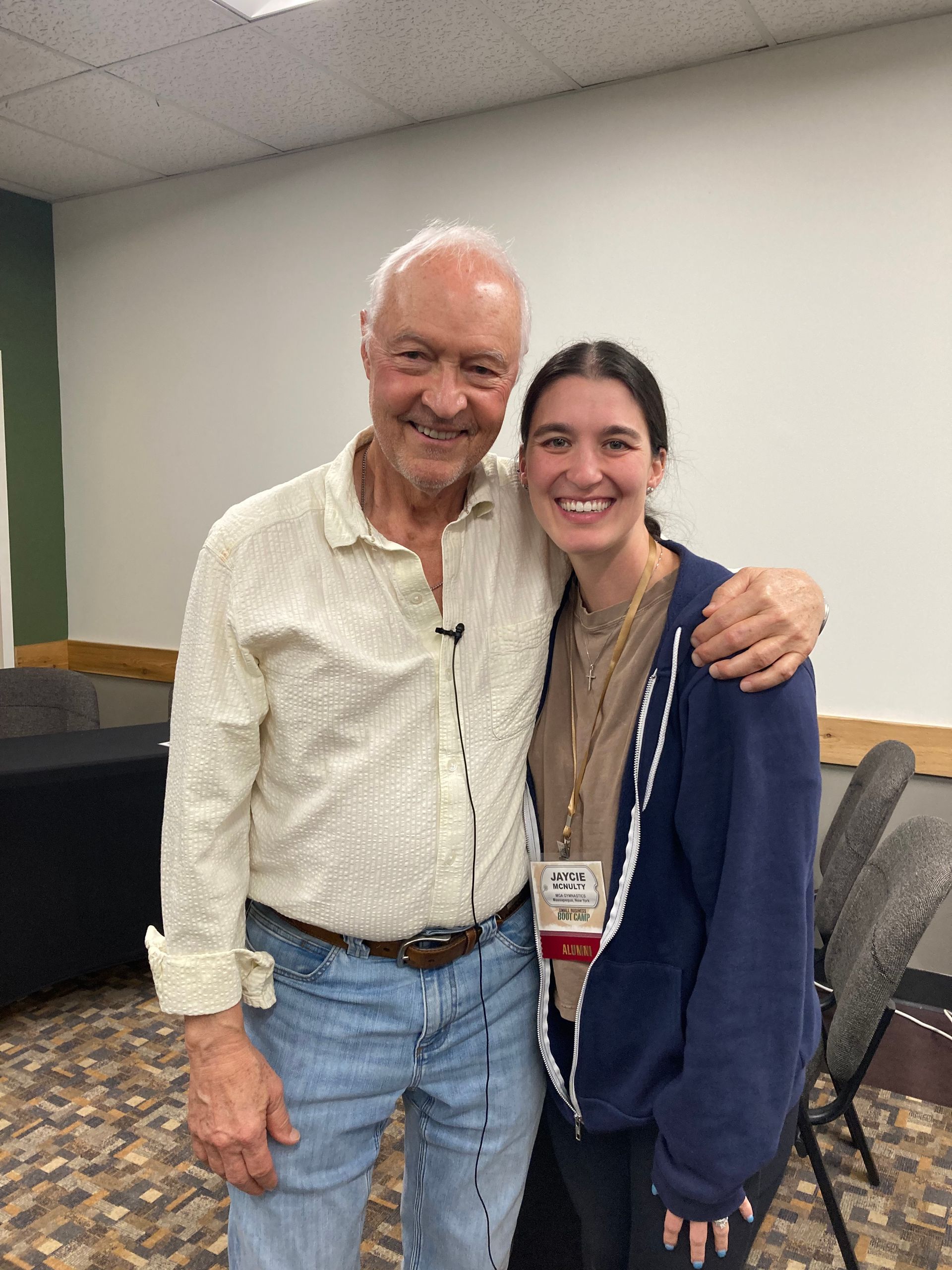 Jeff Metzger and attendee posing together indoors, one with an arm around the other.