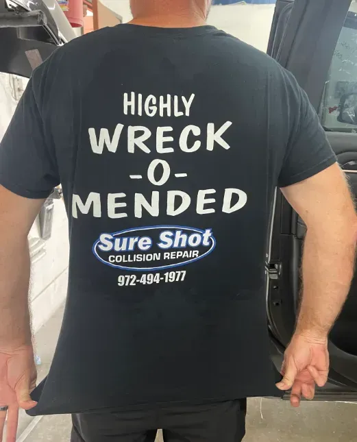 A person wearing a black t-shirt printed with 