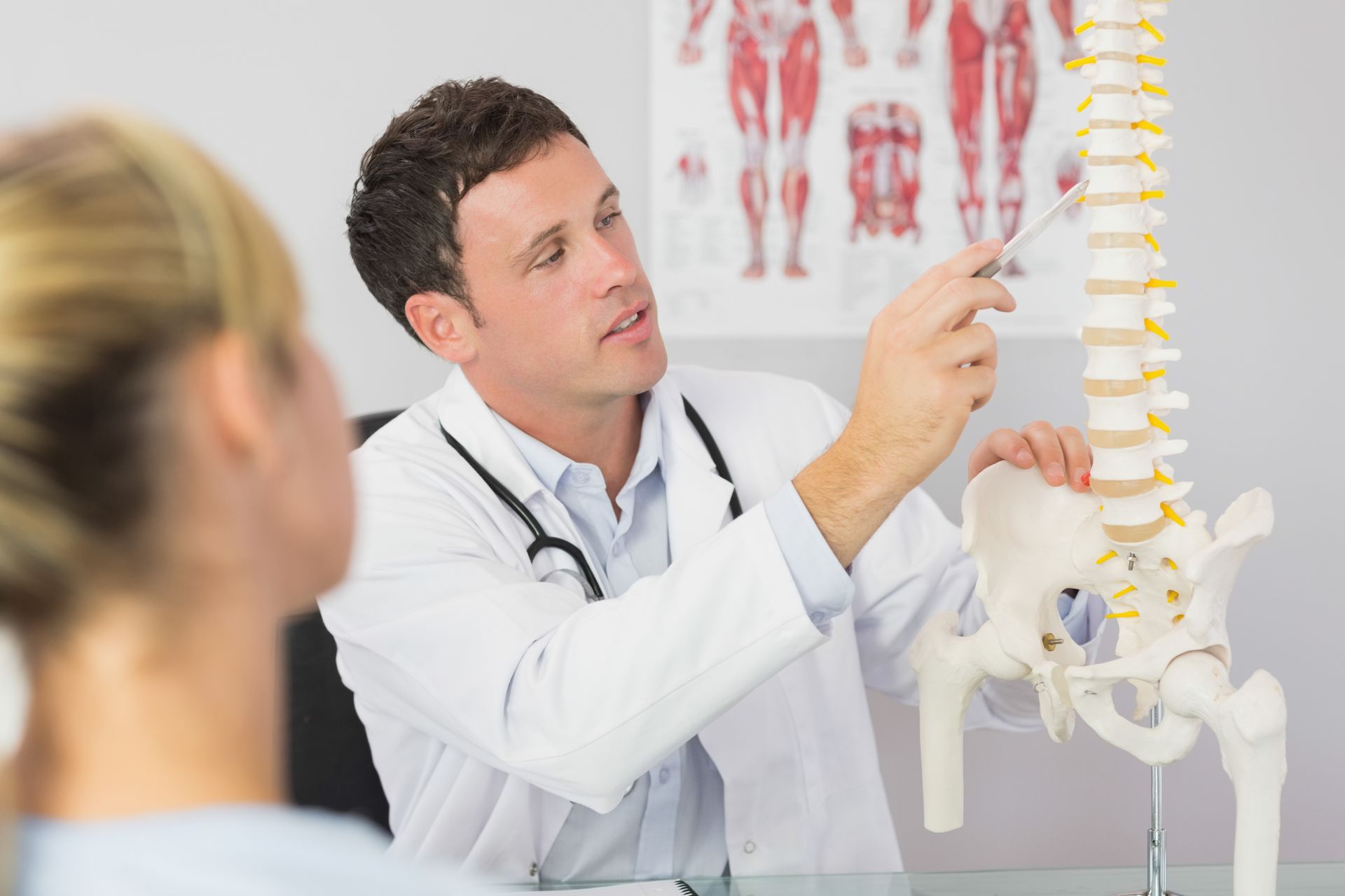 Chiropractor Checking the Back of the Pregnant Woman