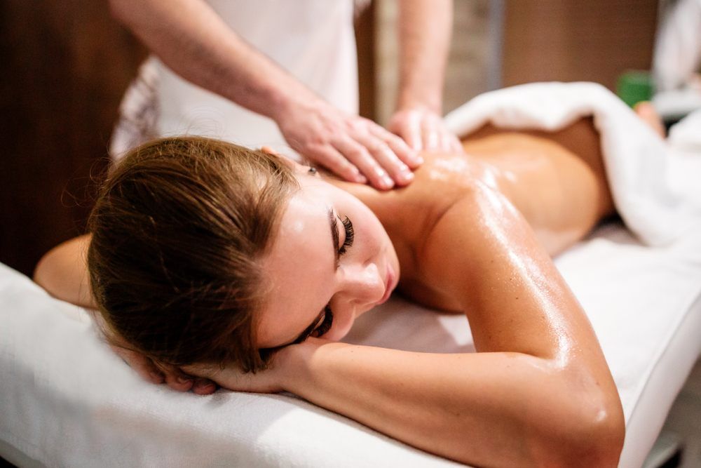A Woman Is Laying On A Massage Table Getting An Oil Massage — Ocean Bliss Thai Massage In Ballina, NSW