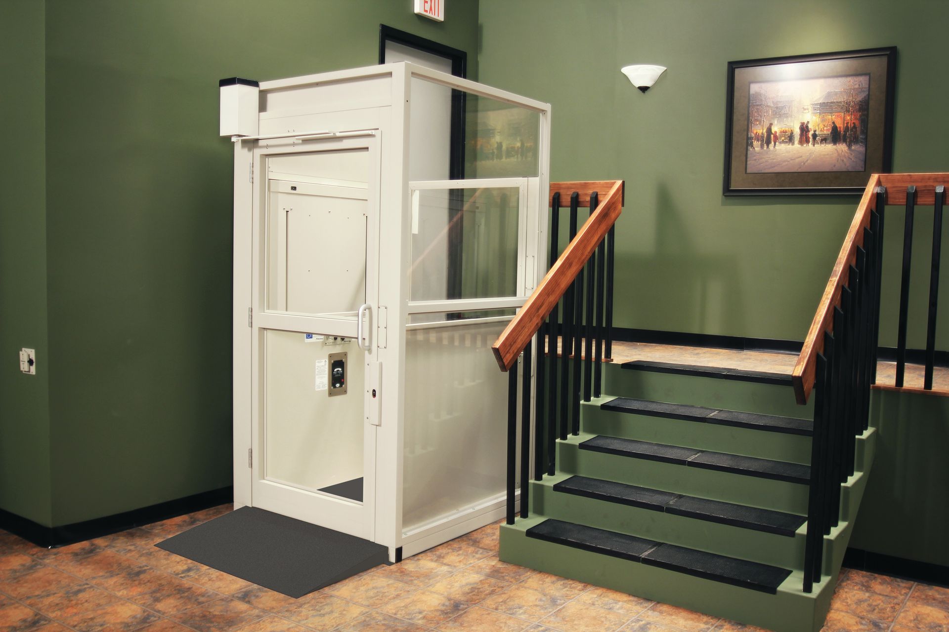 Front steps of a house with a white stairlift, brown stairs, white railings, and flower beds