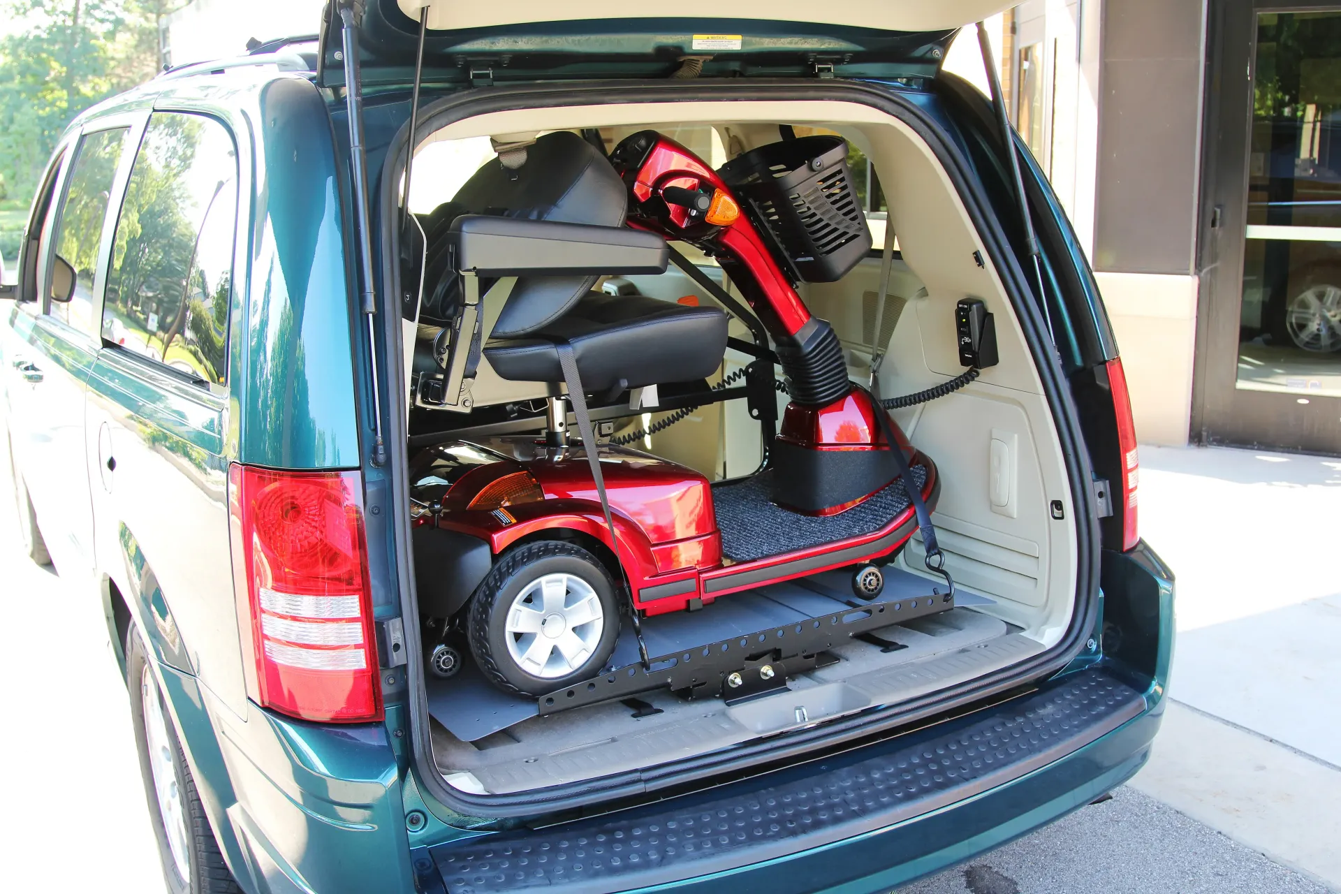 Bruno Joey VSL-4400 interior platform vehicle lift stowing a mobility device inside a cargo area