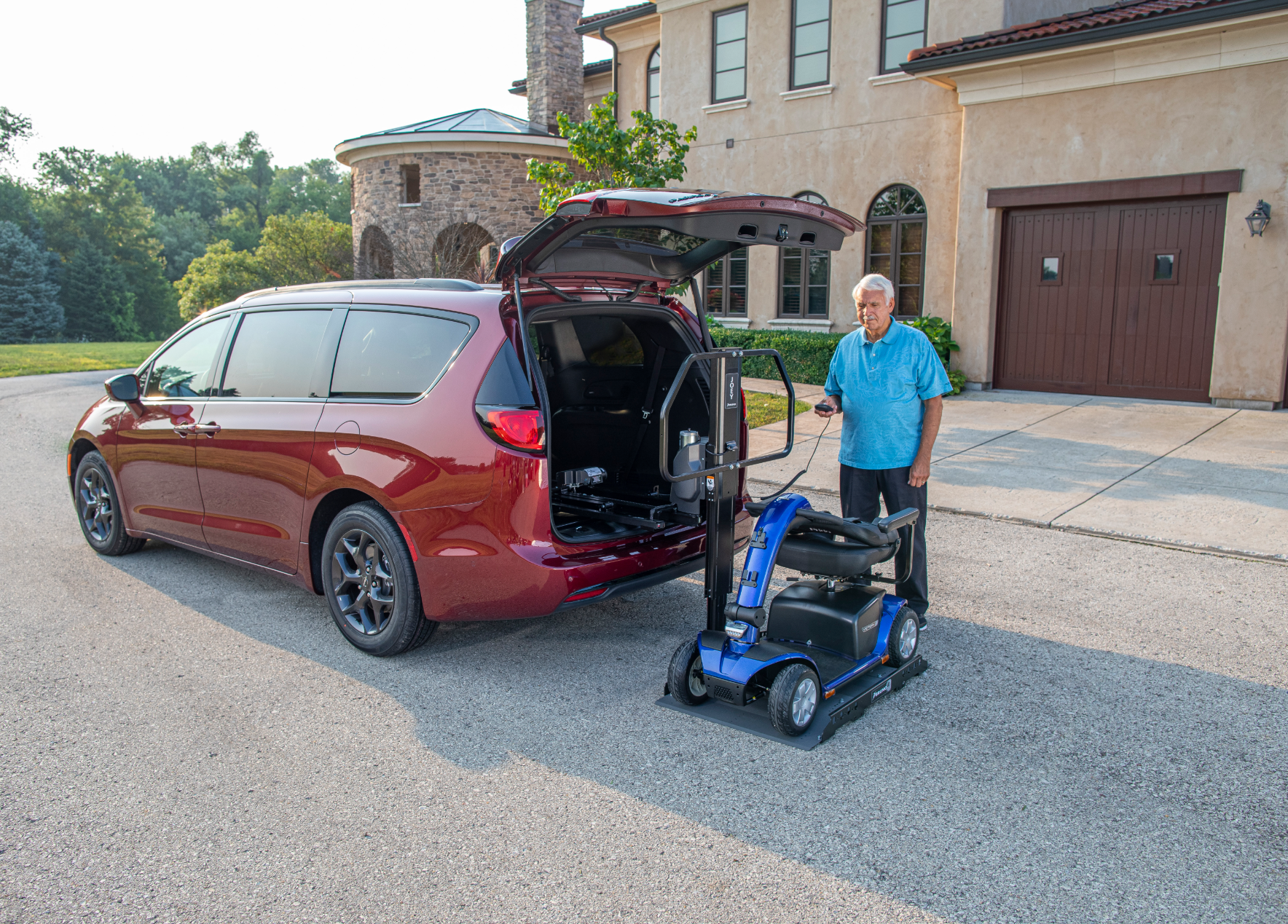 A man loading a mobility scooter into the back of a van using a Bruno interior vehicle lift installed by Altamira Ltd.