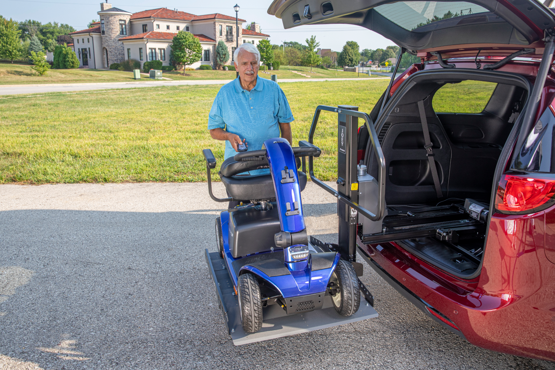 A mobility scooter on an automobile lift installed by Altamira Ltd. in Indianapolis