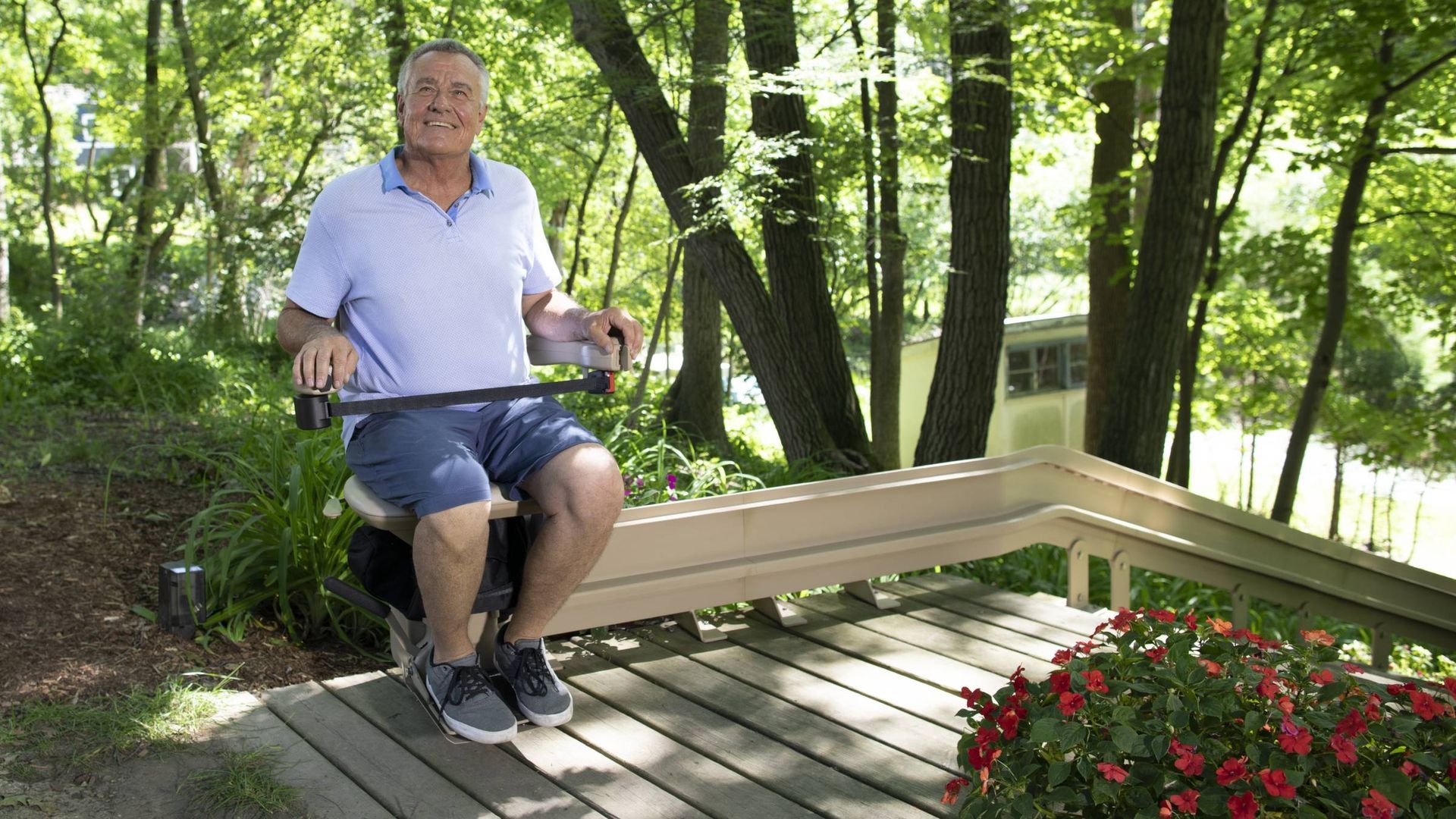 Outdoor curved stairlift installed along exterior steps of a home
