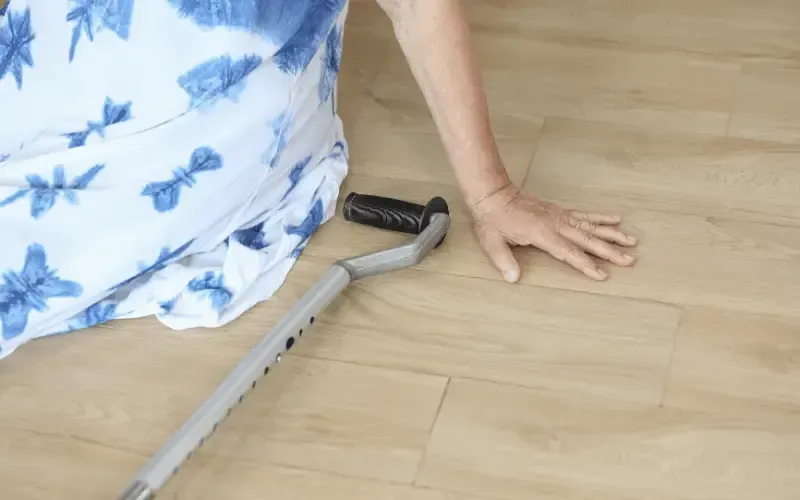 A cane resting on the ground near a stairway