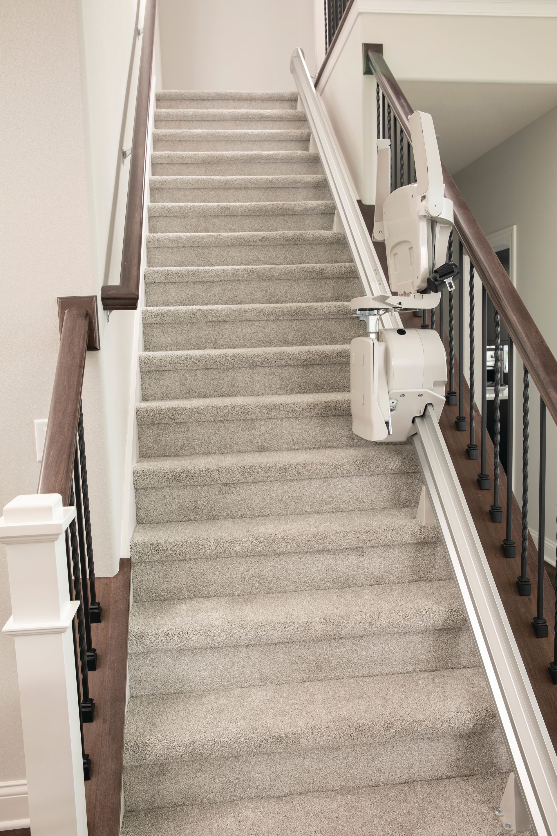 A stairlift going up the stairs in a New Jersey house, installed by Altamira Ltd.