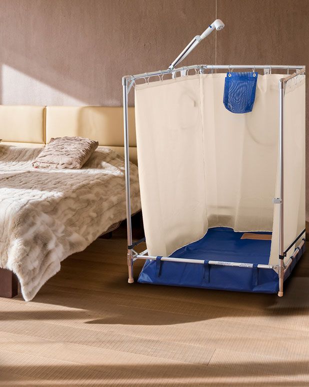 FAWSsit portable roll-in shower set up in a bedroom