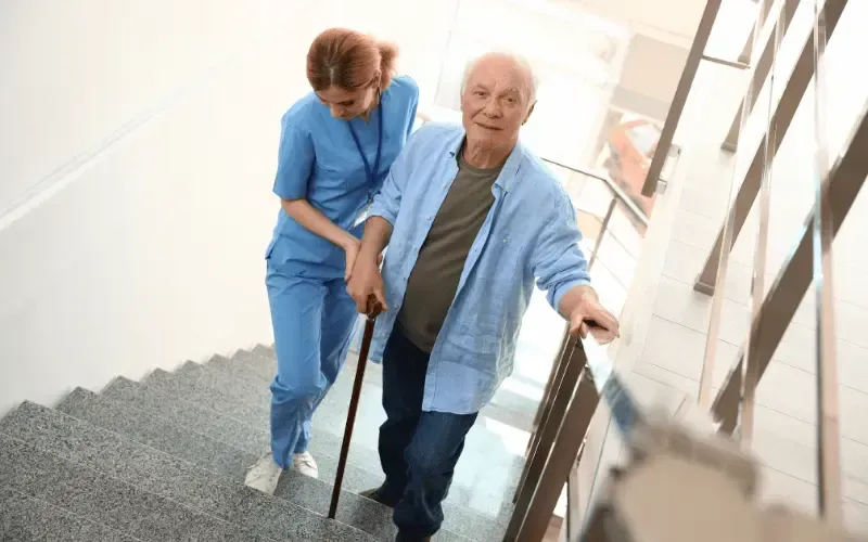 Family member helping a loved one on the stairs