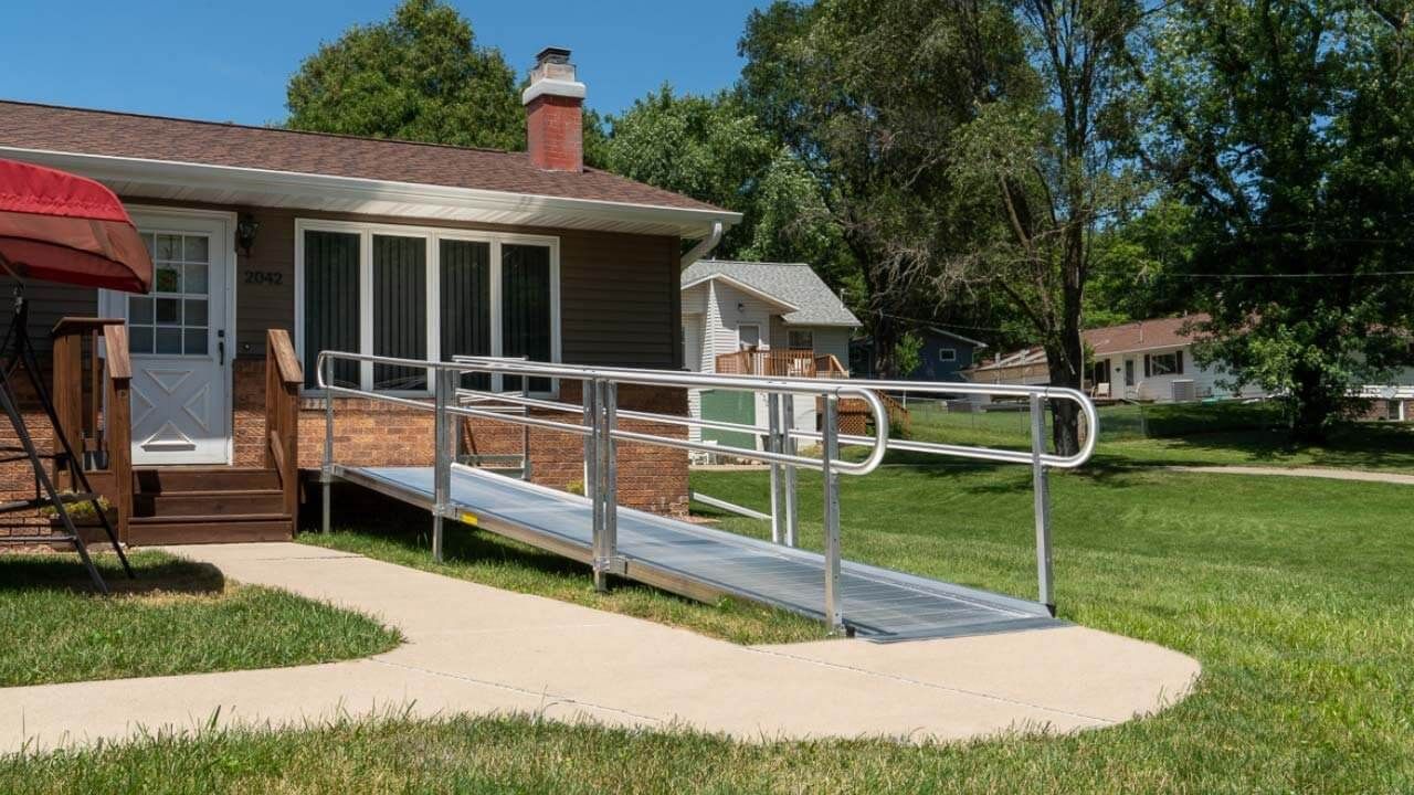 A house with a modular wheelchair ramp leading to the front door, installed by Altamira Ltd.