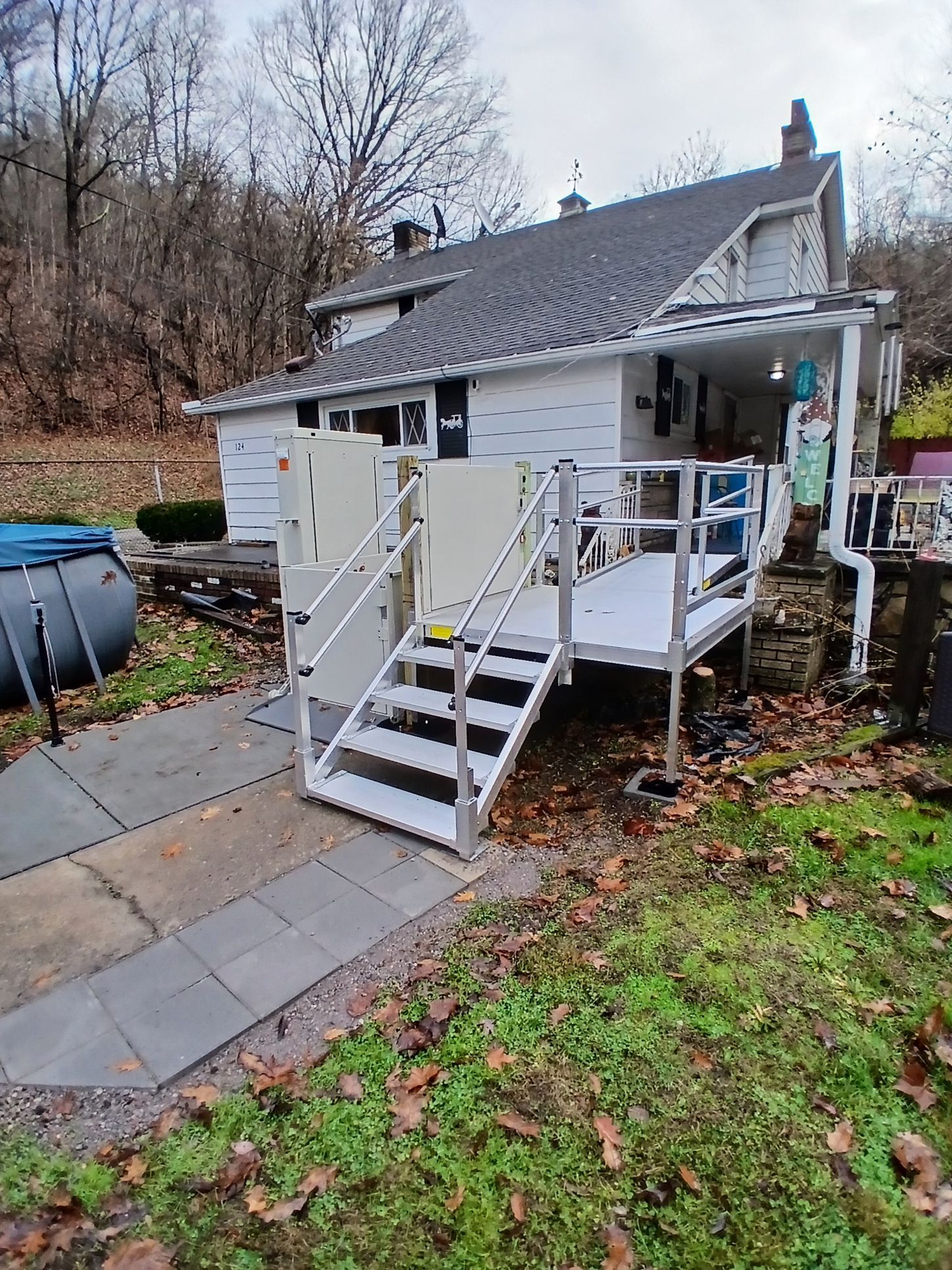Home entrance with both a wheelchair ramp and a vertical platform lift installed